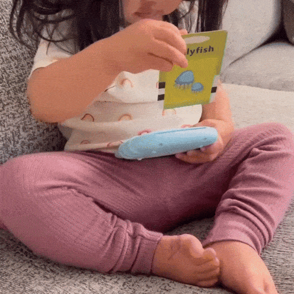 Kid playing with learning flashcard toy MyFirstWords